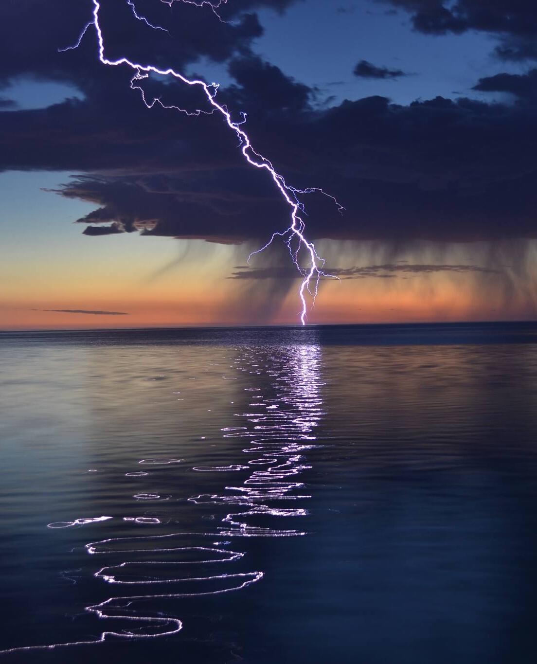 Lightning on calm water cropper